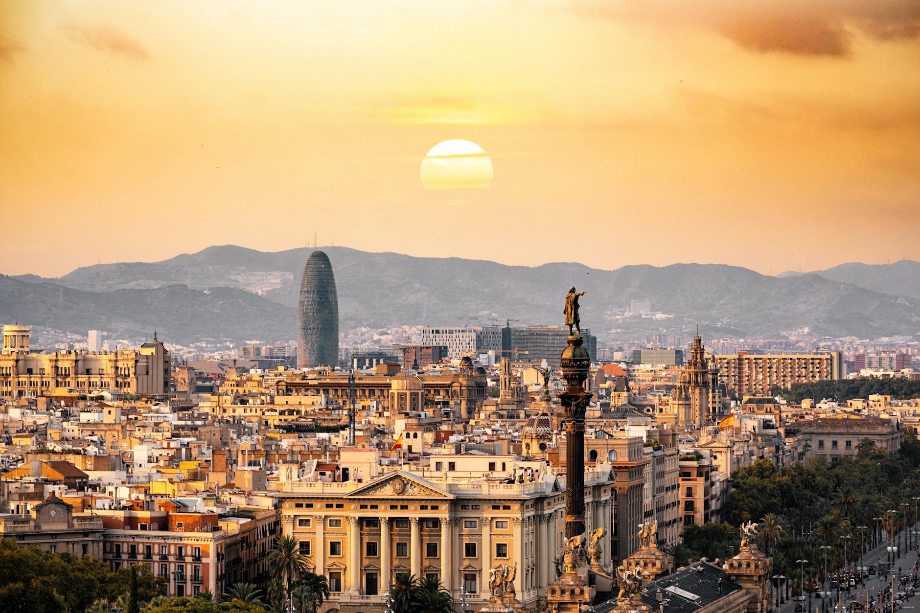 The barcelona skyline at sunset — photo by Aleksandar Pasaric via Pexels