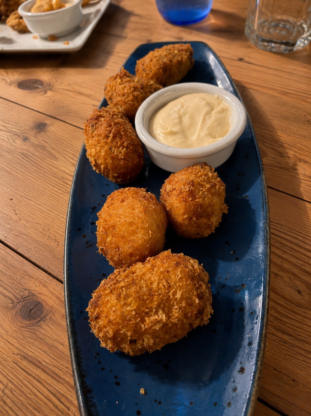 Golden croquetas with dipping sauce at El Rincón de Pepe in Santa Eulària, Ibiza.