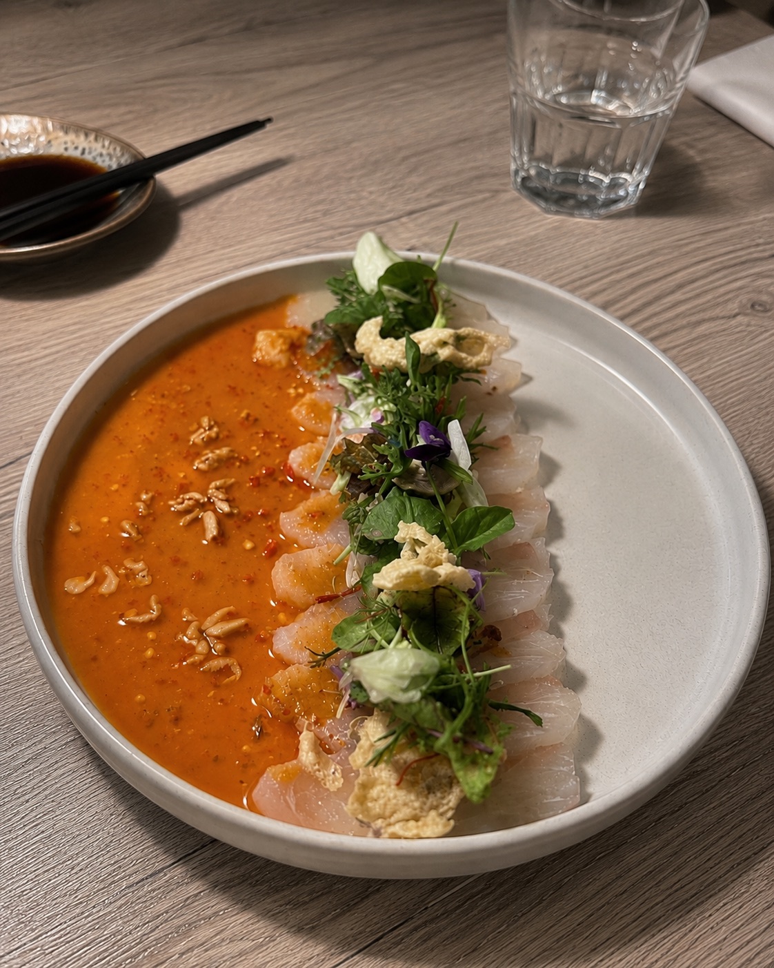 Dived scallops carpaccio with herbs and orange sauce at NAGAI Ibiza Japanese restaurant.