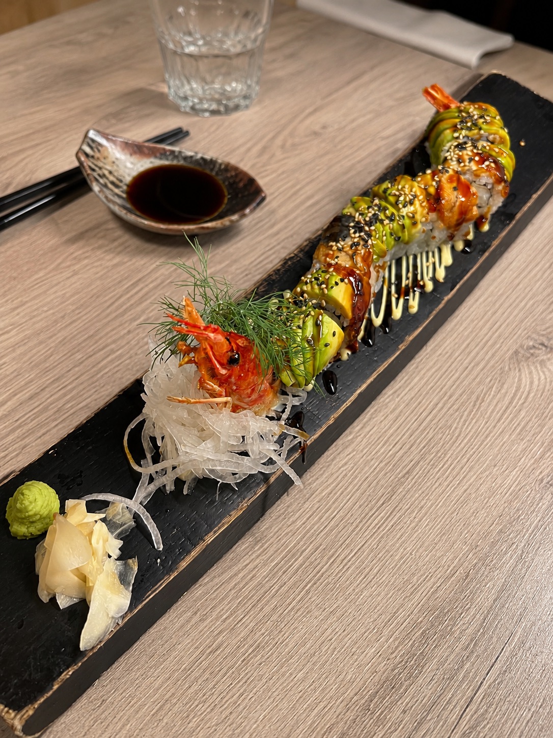 Dragon Roll sushi with avocado, prawn and sauce at NAGAI Ibiza Japanese restaurant.
